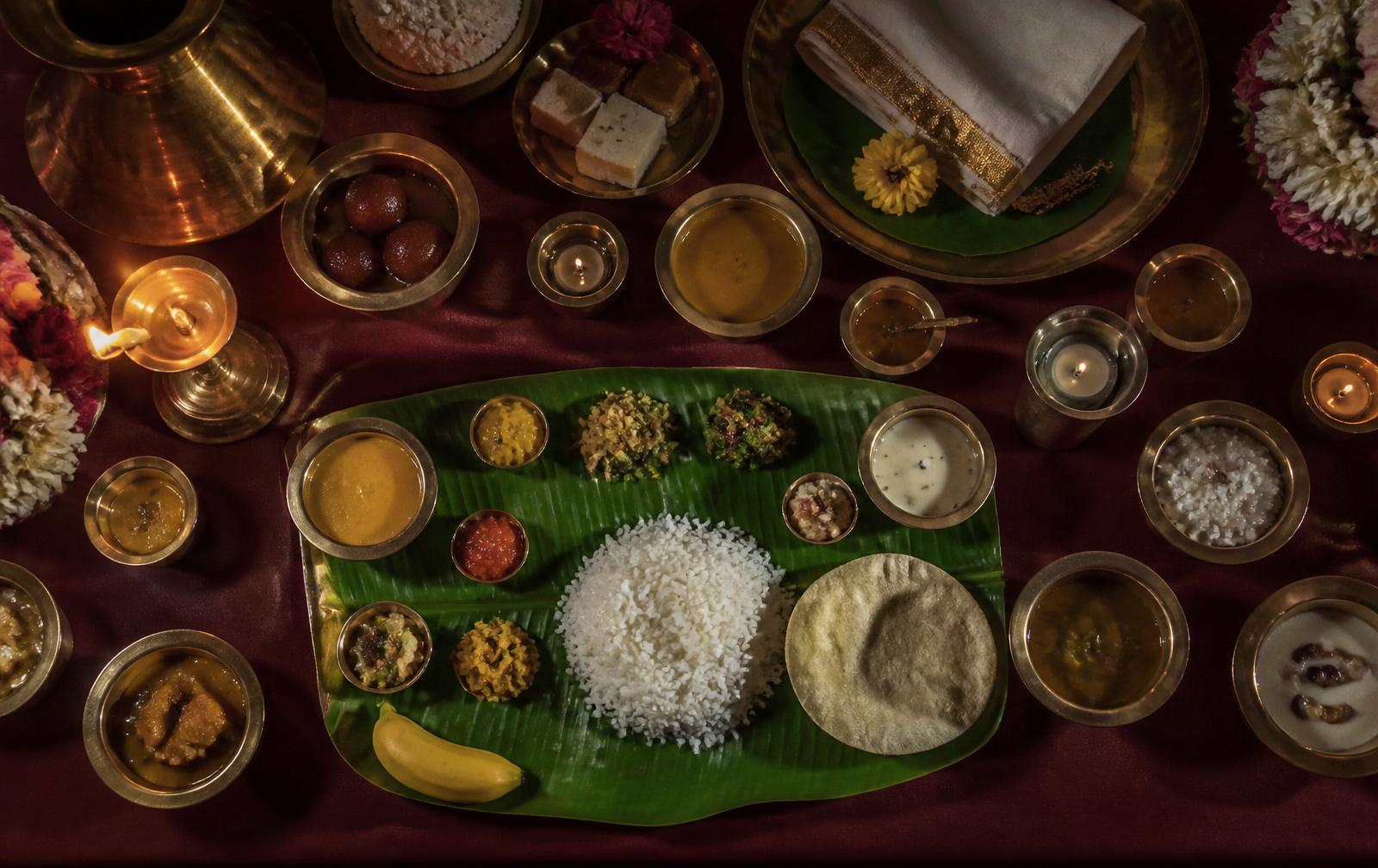 Traditional South Indian banana leaf feast laid out in brass vessels
